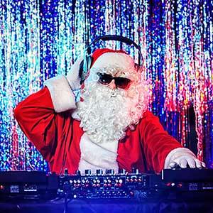 DJ Santa Claus mixing up some Christmas cheer. Disco lights in t